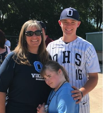 A family of three at the son's baseball game