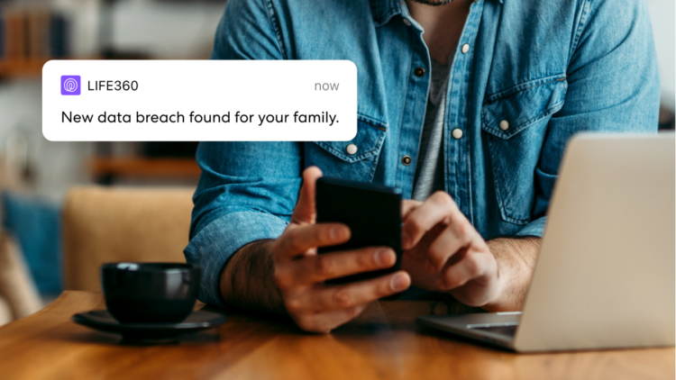 Sitting man looking at phone as he receives a notification from Life360 reading "New data breach found for your family"