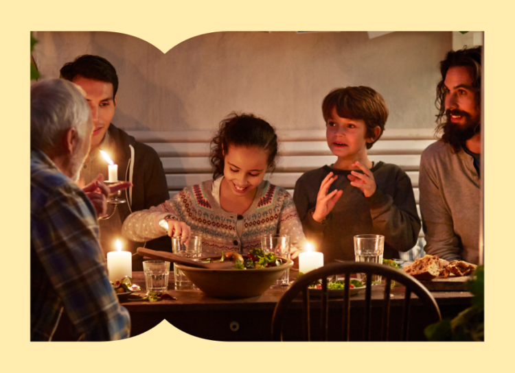 Picture of a family with young children enjoying thanksgiving at a candle light dinner