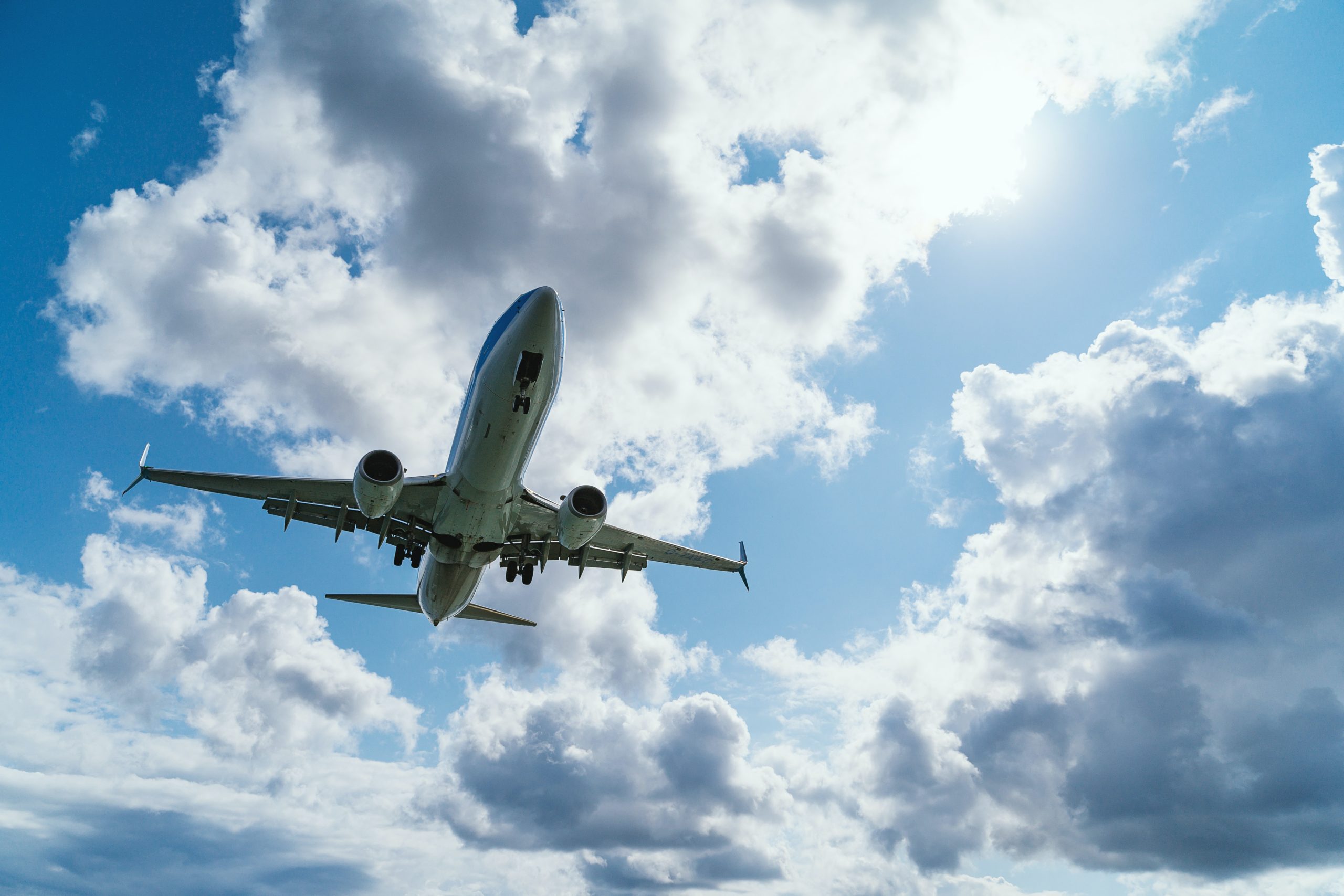 Airplane taking off and flying on a partly cloudy day