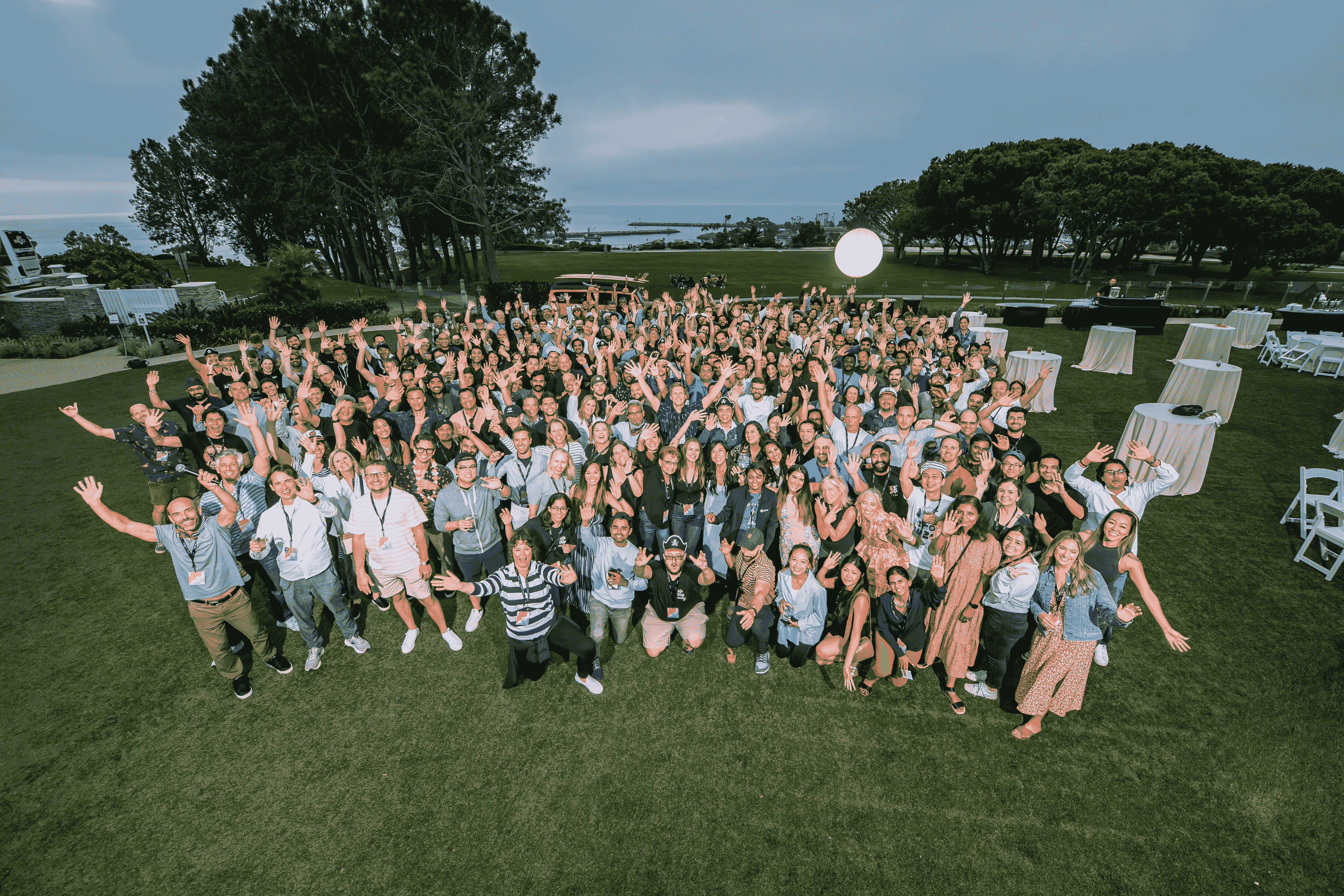 Life360 employees posing for a company picture outside at dusk