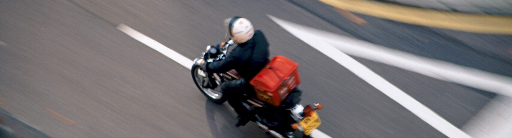 Motorcycle riding down a city street