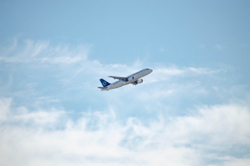 Airplane taking off on a slightly cloudy day